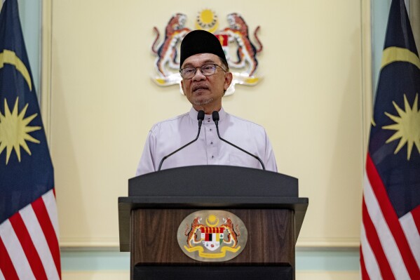 FILE - In this photo provided by the Prime Minister Office, Malaysia's Prime Minister Anwar Ibrahim speaks at a news conference on his first day at the prime minister's office in Putrajaya, Malaysia, Nov. 25, 2022. The director and producer of a banned Malaysian film that explores the afterlife were charged Wednesday, Jan. 17, 2024, with offending the religious feelings of others in a rare criminal prosecution of filmmakers, slammed by critics as an attack on freedom of expression. Human Rights Watch has accused Anwar’s government of prosecuting the two filmmakers to win political support from Malays. (Prime Minister office via AP, File)
