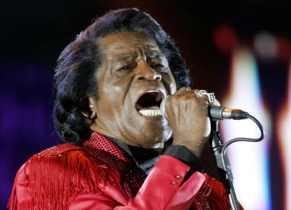 FILE - In this July 6, 2005 file photo, James Brown performs on stage during the Live 8 concert at Murrayfield Stadium in Edinburgh, Scotland. The family of entertainer James Brown has reached a settlement ending a 15-year battle over late singer’s estate. David Black, an attorney representing Brown’s estate, confirmed to The Associated Press on Friday, July 23, 2021 that the agreement was reached July 9.  (AP Photo/Matt Dunham, File)