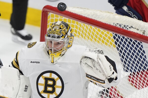 Boston Bruins goaltender Jeremy Swayman (1) deflects a shot during the second period of Game 1 of the second-round series of the Stanley Cup Playoffs against the Florida Panthers, Monday, May 6, 2024, in Sunrise, Fla. (AP Photo/Wilfredo Lee)