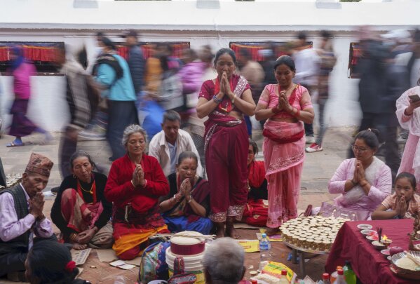 Tamang community members perform rituals during Temal festival at Boudhanath Stupa in Kathmandu, Nepal, Wednesday, April 5, 2023. Tamangs light butter lamp and perform rituals to pay homage to deceased loved ones on this day. (AP Photo/Niranjan Shrestha)