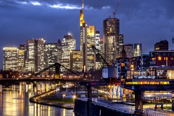 FILE - The buildings of the banking district are pictured in Frankfurt, Germany, on Feb. 19, 2024. Germany businesses remain mired in pessimism despite a small uptick in the latest survey, as Europe's largest economy struggles with shortages of skilled labor, slower global trade, and political squabbling. (AP Photo/Michael Probst)