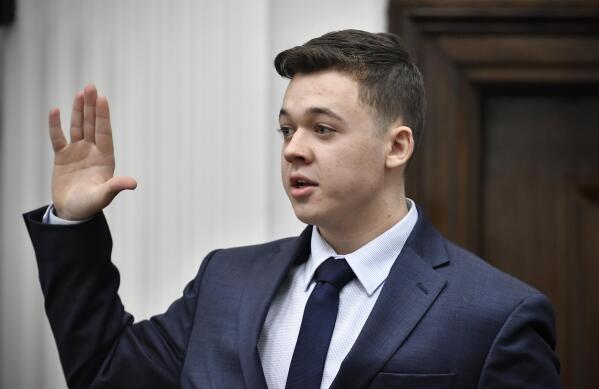 Kyle Rittenhouse is sworn in before testifying in his trial at the Kenosha County Courthouse in Kenosha, Wis., on Wednesday, Nov. 10, 2021.  Rittenhouse is accused of killing two people and wounding a third during a protest over police brutality in Kenosha, last year.  (Sean Krajacic/The Kenosha News via AP, Pool)