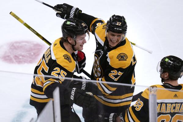 Boston Bruins defenseman Brandon Carlo (25) is congratulated after his goal against the Florida Panthers during the first period of an NHL hockey game, Monday, Dec. 19, 2022, in Boston. (AP Photo/Charles Krupa)