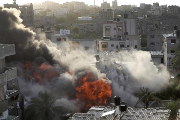 Smoke and fire rise from an explosion caused by an Israeli airstrike targeting a building in Gaza, Saturday, May 13, 2023. The building was owned by an Islamic Jihad official. (AP Photo/Ashraf Amra)