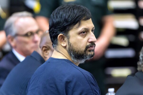 
              Nouman Raja listens to Chief Assistant State Attorney Adrienne Ellis during his sentencing hearing Thursday, April 25, 2019 in West Palm Beach, Fla. Raja, a former Palm Beach Gardens police officer, was convicted on one count each of manslaughter by culpable negligence and first-degree attempted murder. in the killing of  stranded motorist Corey Jones Oct. 18, 2015. (Lannis Waters/Palm Beach Post via AP, Pool)
            