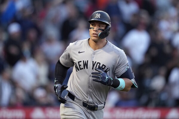 New York Yankees' Aaron Judge looks toward his teammates in the dugout as he runs to first after hitting a two-run home run during the fourth inning of a baseball game against the Los Angeles Angels Thursday, May 30, 2024, in Anaheim, Calif. (AP Photo/Mark J. Terrill)