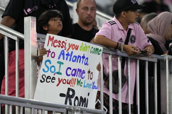 A young fan holds up a sign for Inter Miami forward Lionel Messi before the start of an MLS soccer match between Inter Miami and Toronto FC, Wednesday, Sept. 20, 2023, in Fort Lauderdale, Fla. While Messi's immediate impact is off-the-charts, it remains to be seen whether fans will be wooed to the league as a whole.(AP Photo/Wilfredo Lee)