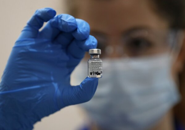 A nurse holds a phial of the Pfizer-BioNTech COVID-19 vaccine at Guy's Hospital in London, Tuesday, Dec. 8, 2020, as the U.K. health authorities rolled out a national mass vaccination program.  U.K. regulators said Wednesday Dec. 9, 2020, that people who have a “significant history’’ of allergic reactions shouldn’t receive the new Pfizer/BioNTech vaccine while they investigate two adverse reactions that occurred on the first day of the country’s mass vaccination program.  (AP Photo/Frank Augstein, Pool)
