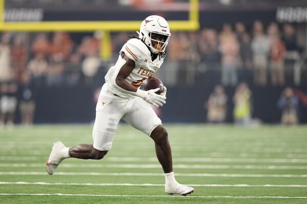 FILE - Texas running back CJ Baxter (4) runs the ball during the Big 12 Conference championship NCAA college football game against Oklahoma State in Arlington, Texas, Saturday, Dec. 2, 2023. (AP Photo/Tony Gutierrez, File)