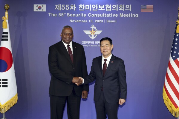 In this photo provided by the South Korea Defense Ministry, U.S. Secretary of Defense Lloyd Austin, left, and his South Korean counterpart Shin Won-sik shake hands for a photo ahead of the 55th Security Consultative Meeting (SCM) at the defense ministry in Seoul, South Korea, Monday, Nov. 13, 2023. (South Korea Defense Ministry via AP)