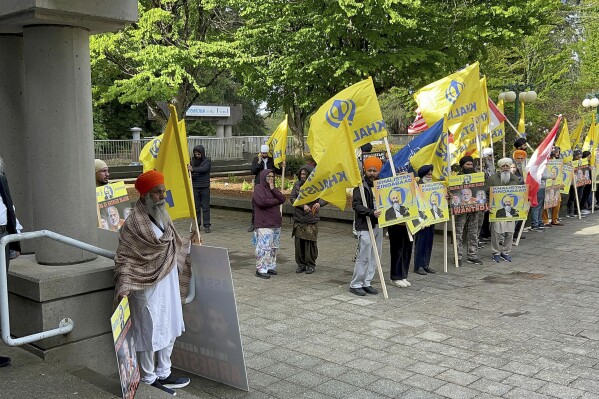 Members of British Columbia's Sikh community gather in front of the courthouse in Surrey, British Columbia, Tuesday, May 7, 2024. Three men accused of murdering temple leader Hardeep Singh Nijjar made their first court appearance by video. (Chuck Chiang/The Canadian Press via AP)