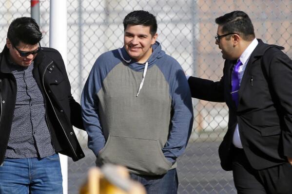 FILE - In this March 29, 2017 file photo, Daniel Ramirez Medina, center, who is a participant in the Deferred Action for Childhood Arrivals Program, walks out of the Northwest Detention Center in Tacoma, Wash., with his attorney, Luis Cortes, right, and his brother, left, who has not been identified by name, after Ramirez was released from federal custody. Ramirez who was arrested by U.S. immigration agents in 2017 despite his participation in a program designed to protect those brought to the U.S. illegally as children will be allowed to remain in the country for at least the next four years under a settlement with the Justice Department. (AP Photo/Ted S. Warren, File)