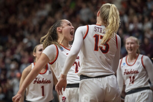 Virginia Tech's Olivia Summiel, left, celebrates with Clara Strack (13) during the first half of a second-round college basketball game against Baylor in the women's NCAA Tournament in Blacksburg, Va., Sunday, March 24, 2024. (AP Photo/Robert Simmons)