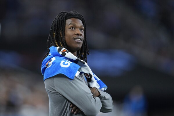 FILE - Detroit Lions wide receiver Jameson Williams watches from the bench area against the Jacksonville Jaguars during an preseason NFL football game in Detroit, Saturday, Aug. 19, 2023. Detroit wide receiver Jameson Williams and Tennessee right tackle Nicholas Petit-Frere start their six-game suspensions for betting at work Tuesday at the NFL's final roster cutdown deadline. At least they'll be able to rejoin their teams this season. (AP Photo/Paul Sancya, File)