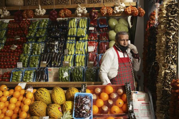 A vendor waits for customers at a food shop, in Ankara, Turkey, Thursday, Jan. 20, 2022. Turkey's central bank kept a key interest rate unchanged on Thursday, halting a string of rate cuts that triggered a currency crisis and sent prices skyrocketing. Inflation in Turkey surged 36% last month - reaching a 19-year high and leaving many in the country of nearly 84 million struggling to buy food and other basic goods.(AP Photo/Burhan Ozbilici)