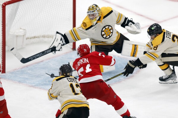 Detroit Red Wings' Dylan Larkin (71) scores on Boston Bruins' Jeremy Swayman (1) during the third period of an NHL hockey game, Friday, Nov. 24, 2023, in Boston. (AP Photo/Michael Dwyer)