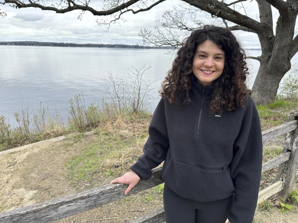 Hannah Kass, one of 61 people indicted on racketeering charges in connection with Atlanta's "Stop Cop City" movement, stands in front of Lake Mendota in Madison, Wis., on May 2, 2025. (AP Photo/Scott Bauer)