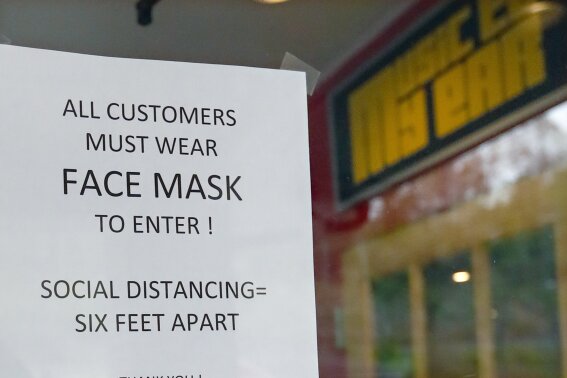 A sign tells customers the protocol to enter the "Music to My Ears" record and HiFi store, Thursday, May 14, 2020, in Pittsburgh, as he prepares to re-open Friday when some of the COVID-19 restrictions will be lessened in the city and several western Pennsylvania counties as they move from red to yellow status. (AP Photo/Keith Srakocic)