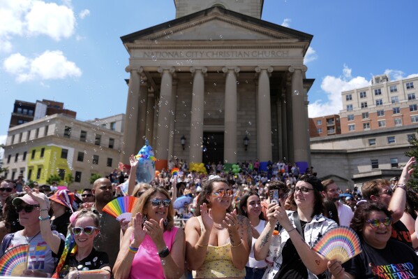 People watch the World Pride parade, Saturday, June 7, 2025, in Washington. (AP Photo/Julia Demaree Nikhinson)