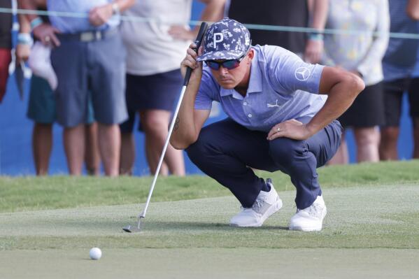 Rickie Fowler lines up his putt on the 18th green during the second round of the Wyndham Championship golf tournament, Friday, Aug. 5, 2022, in Greensboro, N.C. (AP Photo/Reinhold Matay)