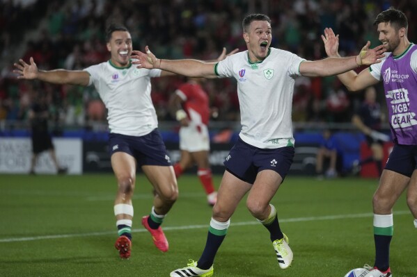 Ireland's Johnny Sexton, centre, celebrates after scoring a try during the Rugby World Cup Pool B match between Ireland and Tonga at the State de la Beaujoire in Nantes, France Saturday, Sept. 16, 2023. (AP Photo/Thibault Camus)