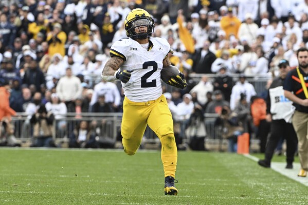 Michigan running back Blake Corum (2) runs against Penn State during the first half of an NCAA college football game, Saturday, Nov. 11, 2023, in State College, Pa. (AP Photo/Barry Reeger)