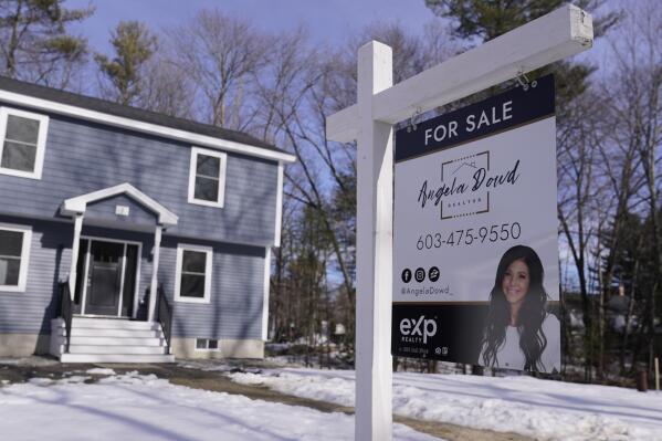 A "For Sale" sign is posted outside a single family home, Tuesday, Feb. 7, 2023, in Derry, N.H. On Tuesday, the National Association of Realtors reports on sales of existing homes in January. (AP Photo/Charles Krupa)