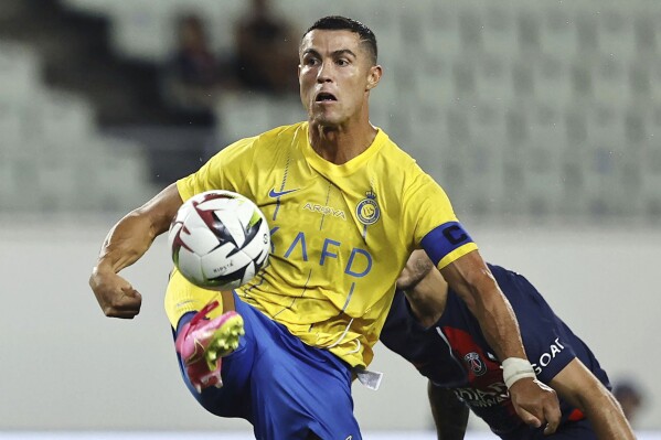 FILE - Al Nassr's Cristiano Ronaldo controls the ball during a friendly soccer match against Paris Saint-Germain in Osaka, western Japan, Tuesday, July 25, 2023. Cristiano Ronaldo, Neymar and Karim Benzema have won a combined total of 11 UEFA Champions League titles and, starting Monday, Sept. 18, 2023, they lead the Saudi Arabian challenge in the Asian edition.(Kyodo News via AP, File)