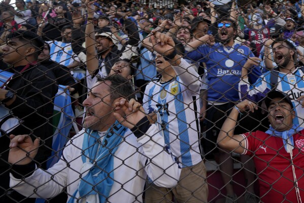 Fans of Argentina cheer during a qualifying soccer match for the FIFA World Cup 2026 against Bolivia at the Hernando Siles stadium in La Paz, Bolivia, Tuesday, Sept. 12, 2023. (AP Photo/Juan Karita)