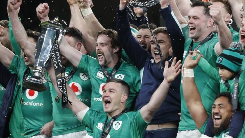 FILE - Ireland's Johnny Sexton, bottom center, holds the trophy as he celebrates with teammates at the end of the Six Nations rugby union international match between Ireland and England at the Aviva Stadium, in Dublin, Saturday, March 18, 2023. A new biennial international rugby competition featuring teams from the Six Nations and the southern hemisphere is set to start in 2026. Six Nations Rugby and SANZAAR say they are working on a new competition to take place in the existing July and November international windows. (AP Photo/Peter Morrison, File)