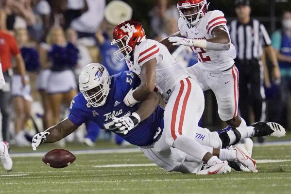 FILE - Tulsa offensive lineman Tyler Smith (56) dives on the ball to recover a fumble in front of Houston linebacker Deontay Anderson (2) during an NCAA college football game Oct. 1, 2021, in Tulsa, Okla. Smith was selected by the Dallas Cowboys in the NFL draft Thursday, April 28. (AP Photo/Sue Ogrocki, File)