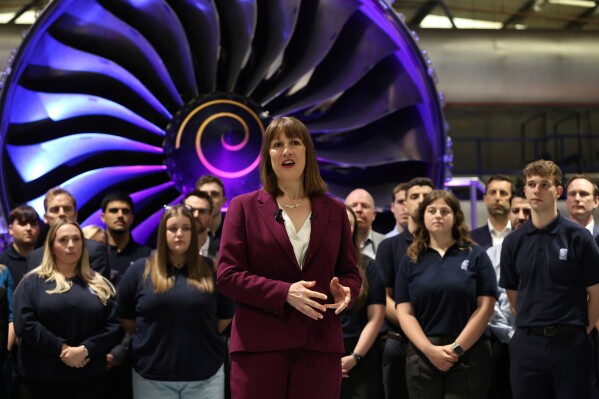 Britain's Chancellor of the Exchequer Rachel Reeves, center, speaks with the media at the Rolls-Royce factory in Derby, England following the announcement from the Office for National Statistics that the U.K. economy grew by 0.7% between January and March, Thursday, May 15, 2025. (Darren Staples/PA via AP)
