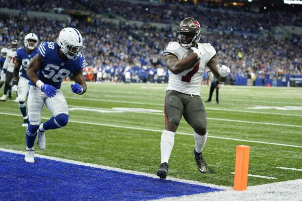 Tampa Bay Buccaneers' Leonard Fournette (7) goes in for a touchdown against Indianapolis Colts' Bobby Okereke (58) during the first half of an NFL football game, Sunday, Nov. 28, 2021, in Indianapolis. (AP Photo/Michael Conroy)