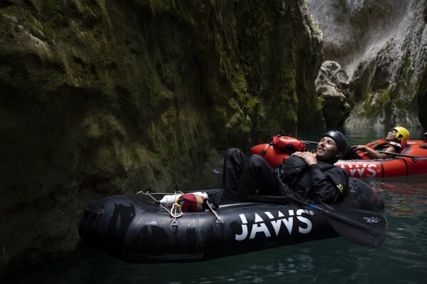Anthony Coudray of Secret River Tours practices packrafting along the Verdon Gorge in southern France, Monday, June 19, 2023. "These days we have to be conscious that there will be less and less water in the river for us, so we have to know how to adapt," Coudray said. He's introduced "drought-proof" packrafting into the region over the past of couple of years, where the inflatable bottom allows it to float in much shallower waters in the Gorges du Verdon. (AP Photo/Daniel Cole)