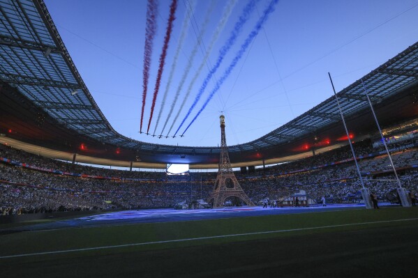 The Patrouille de France flies over the Stade de France during the opening ceremony of the Rugby World Cup ahead of the Pool A match between France and New Zealand, in Saint Denis , north of Paris, Friday, Sept, 8, 2023. (AP Photo/Aurelien Morissard)