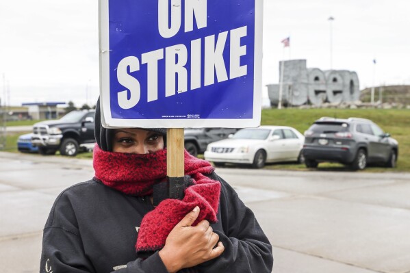 United Auto Workers member Brandi Holmes shivers in a slow drizzle as Team 24 pickets outside a truck entrance to Stellantis Toledo Assembly Complex on Tuesday, Sept. 26, 2023, in Toledo, Ohio. (Isaac Ritchey/The Blade via AP)