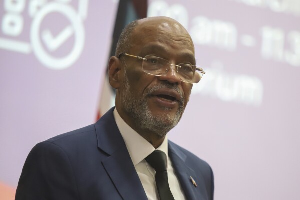 Haiti's Prime Minister Ariel Henry gives a public lecture at the United States International University (USIU) in Nairobi, Kenya, Friday March. 1, 2024. Haitian Prime Minister Ariel Henry said Friday elections in his country need to be held as soon as possible in order to bring stability to the troubled Caribbean nation facing gang violence that threatens to overran government. Henry is in Kenya trying to salvage the deployment of a foreign armed force to Haiti to help combat gangs. (AP Photo/Andrew Kasuku)