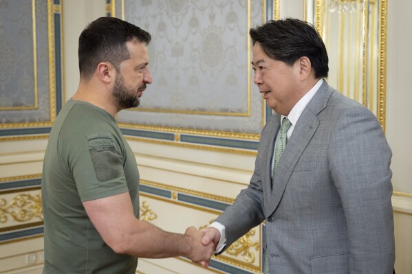 In this photo provided by the Ukrainian Presidential Press Office, Ukrainian President Volodymyr Zelenskyy, left, shakes hands with Japanese Foreign Minister Yoshimasa Hayashi in Kyiv, Ukraine, Saturday, Sept. 9, 2023. (Ukrainian Presidential Press Office via AP)
