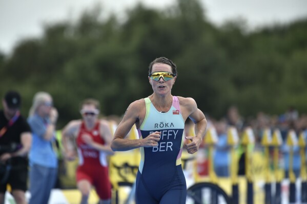 FILE - Flora Duffy of Bermuda competes in the women's individual triathlon at the Commonwealth Games in Birmingham, England, Friday, July 29, 2022. The reigning Olympic champion had contemplated retirement because of a knee injury. (AP Photo/Rui Vieira, File)