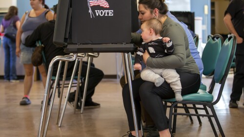 Miranda Padilla holds her 11-month-old son Grayson Sanchez while marking her ballot at a polling center in the South Valley area of Albuquerque, N.M., Nov. 8, 2022. The New Mexico Supreme Court has issued guidance to a lower court on how to handle a challenge to the state’s new congressional maps. The high court in an order filed Wednesday, July 5, 2023 set an Oct. 1 deadline for the district court to resolve the case. (AP Photo/Andres Leighton)