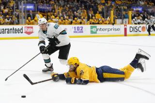 Nashville Predators defenseman Roman Josi (59) slides to block the puck from San Jose Sharks right wing Kevin Labanc (62) in the first period of an NHL hockey game Tuesday, Oct. 26, 2021, in Nashville, Tenn. (AP Photo/Mark Humphrey)