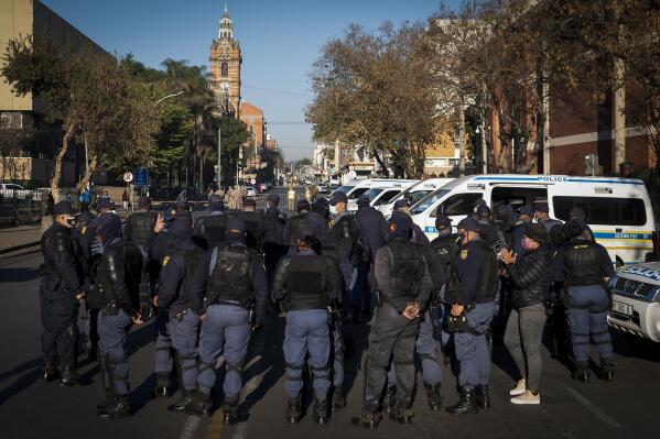 Members of the South African Police Services on patrol outside the High Court in Pietermaritzburg, South Africa, Monday July 19, 2021, where the corruption trial of former South African President Jacob Zuma resumed. The trial continued more than a week after Zuma's imprisonment for contempt of court in a separate case set off rioting. (AP Photo/Shiraaz Mohamed)