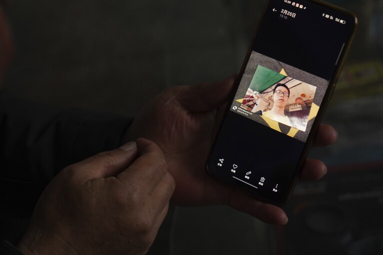 Chinese farmer Li Eryou shows a picture of his son Li Yanlin on his cell phone during an interview with The Associated Press at a village in Handan, in northern China's Hebei province on Feb. 28, 2024. Li, whose son was on the missing Malaysia Airlines flight MH370, continues to search for answers ten years on. The baffling disappearance of flight MH370 still captivates people around the world. The Boeing 777 left Kuala Lumpur with 239 people on March 8, 2014, but dropped off radar screens shortly after and never made it to Beijing, its destination. Investigators say someone deliberately shut down the plane's communications system and took the plane off course. (AP Photo/Emily Wang Fujiyama)