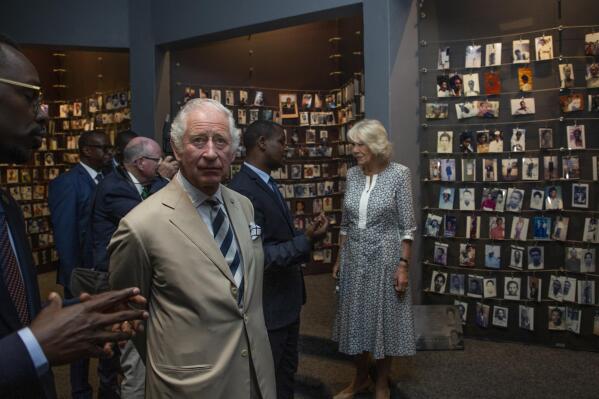 Britain's Prince Charles and Camilla, Duchess of Cornwall, observe an exhibition of family photographs of some of those who died, at the Kigali Genocide Memorial in the capital Kigali, Rwanda Wednesday, June 22, 2022. Prince Charles has become the first British royal to visit Rwanda, representing Queen Elizabeth II as the ceremonial head of the Commonwealth at a summit where both the 54-nation bloc and the monarchy face uncertainty. (AP Photo)
