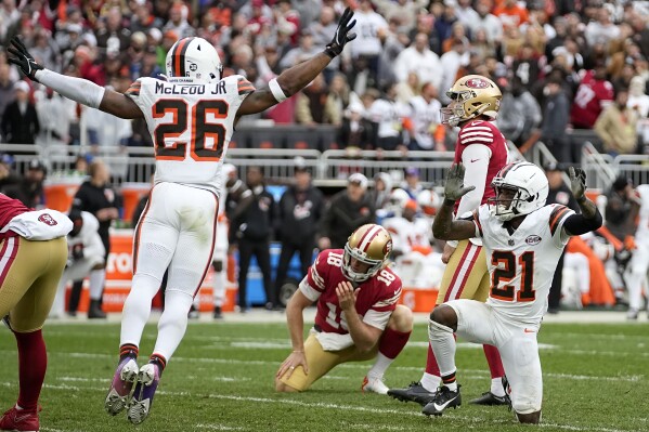 San Francisco 49ers place kicker Jake Moody, top right, and Mitch Wishnowsky (18) react as Cleveland Browns' Rodney McLeod Jr. (26) and Denzel Ward (21) celebrate after Moody missed a field goal during the second half of an NFL football game Sunday, Oct. 15, 2023, in Cleveland. (AP Photo/Sue Ogrocki)