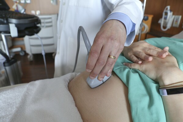 A doctor performs an ultrasound scan on a pregnant woman at a hospital in Chicago, Aug. 7, 2018. (AP Photo/Teresa Crawford, File)
