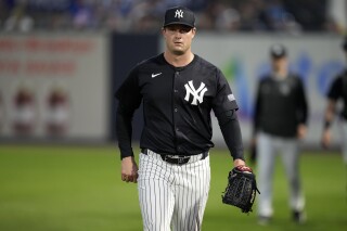 New York Yankees starting pitcher Gerrit Cole walks to the field before a spring training baseball game against the Toronto Blue Jays Friday, March 1, 2024, in Tampa, Fla. (AP Photo/Charlie Neibergall)