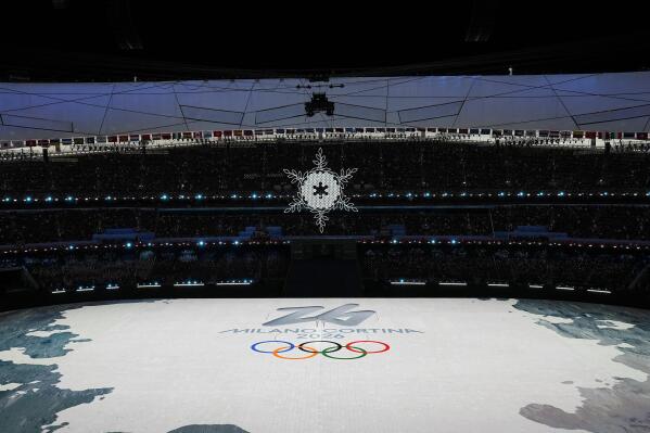 The logo for the 2026 Winter Olympics is displayed during the closing ceremony of the 2022 Winter Olympics, Sunday, Feb. 20, 2022, in Beijing. (AP Photo/Brynn Anderson)