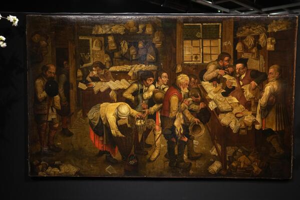 The painting "Payment of the Yearly Dues", also known as "The Peasants' Lawyer" by Pieter Brueghel The Young, estimated to be dating before 1618, is in display at the Drouot auction house in Paris, Monday, March 27, 2023. A rare Brueghel the younger painting found behind a door in French home goes under the hammer in Paris at Drouot Auction house. (AP Photo/Michel Euler)