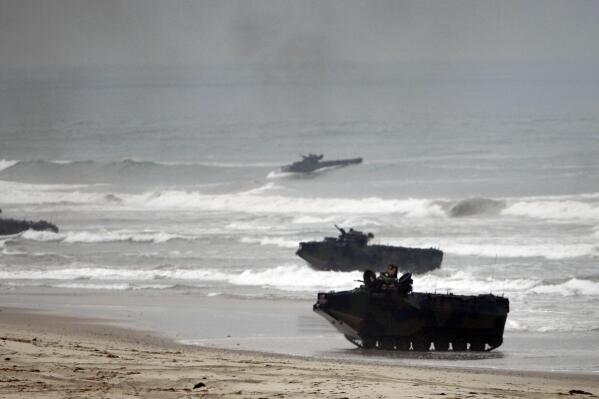 FILE - Amphibious Assault Vehicles storm Red Beach during exercises at Camp Pendleton, Calif., June 2, 2010. The U.S. Marine Corps will keep its new amphibious combat vehicle - a kind of seafaring tank - out of the water while it investigates why two of the vehicles ran into troubles off the Southern California coast this week amid high surf, military officials said Wednesday, July 20, 2022. (AP Photo/Lenny Ignelzi, File)